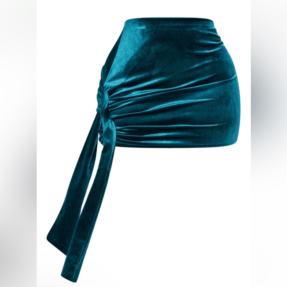 Emerald colored velvet mini skirt, with hang piece that adds an extra flare.